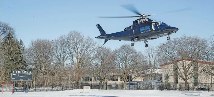  ?? KIRSTEN STICKNEY/SUN-TIMES ?? Miami football coach Mario Cristobal leaves in a helicopter after a visit with Fenwick junior Nate Marshall on Tuesday. “It shows how much of a priority I am for them and their program,” Marshall said.