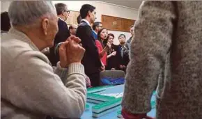  ?? AFP PIC ?? A group of elderly Chinese-Australian­s taking a break from playing mahjong to listen to Labor Party candidate Jennifer Yang (centre) at the Box Hill senior citizens club in Melbourne recently.