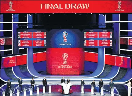  ?? MLADEN ANTONOV/AFP/GETTY IMAGES ?? The 2018 World Cup draw was unveiled at the State Kremlin Palace in Moscow on Friday with host Russia landing in Group A with Saudi Arabia, Egypt and Uruguay, while Group H is the only one without a former champ in Poland, Senegal, Colombia and Japan.