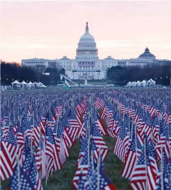  ?? — Reuters ?? Thousands of US flags are seen at the National Mall, as part of a memorial paying tribute to the more than 200,000 people nationwide who have died from COVID-19, near the US Capitol ahead of President-elect Joe Biden’s inaugurati­on, on Monday.
