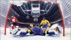  ?? Julio Cortez / Associated Press ?? Canada forward Sidney Crosby, left, scores a goal past Sweden goaltender Henrik Lundqvist during the men’s gold medal game at the 2014 Winter Olympics in Sochi, Russia.