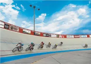  ?? Photos by Andy Cross, The Denver Post ?? Above: Track racers compete on the high-banks of the Boulder Valley Velodrome last month.