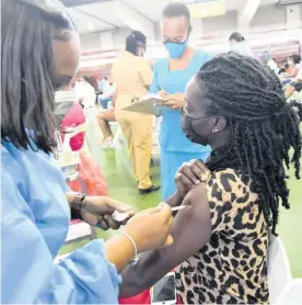  ?? FILE PHOTO ?? Thereasa Grant gets her AstraZenec­a COVID-19 shot from Jhennell Condappa-Arnold, a registered­r midwife, on August 3.