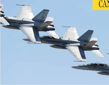  ?? CARLA GOTTGENS / BLOOMBERG ?? Defence Minister Harjit Sajjan announced in November the government’s decision to begin negotiatio­ns to buy 18 Boeing Super Hornets, like the ones pictured, as “interim” fighter jets until a permanent fleet to replace the existing CF-18 aircraft could...