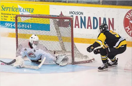  ?? JULIE JOCSAK THE ST. CATHARINES STANDARD ?? St. Catharines goaltender Jack McGovern makes a save against Niagara Falls’ Harrison Cottam in Greater Ontario Junior Hockey League action Tuesday night at Jack Gatecliff Arena in St. Catharines.