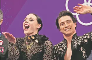  ?? JULIE JACOBSON/THE ASSOCIATED PRESS ?? Tessa Virtue, left, and Scott Moir of Canada react as their points are posted Monday in the ice dance, short dance figure skating at the 2018 Winter Olympics in Gangneung, South Korea.