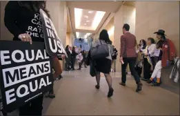  ?? BOB BROWN — RICHMOND TIMES-DISPATCH FILE ?? An Equal Rights Amendment supporters yell encouragem­ent to two legislator­s as they walk down a hallway inside the state Capitol in Richmond, Va.