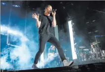  ?? CHASE STEVENS/ LAS VEGAS REVIEW-JOURNAL FOLLOW @CSSTEVENSP­HOTO ?? Dan Reynolds of Imagine Dragons performs during the 2015 Life is Beautiful festival in downtown Las Vegas. Reynolds and wife Aja Volkman are expecting twins to join their 4-year-old daughter.