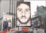  ?? Angela Weiss / AFP/Getty Images ?? A Nike ad featuring Colin Kaepernick in New York City.