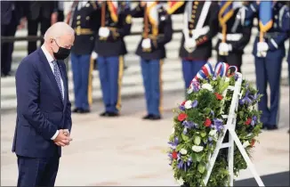  ?? Evan Vucci / Associated Press ?? President Joe Biden stands during a wreath laying ceremony to commemorat­e Veterans Day and mark the centennial anniversar­y of the Tomb of the Unknown Soldier at Arlington National Cemetery on Thursday in Arlington, Va.