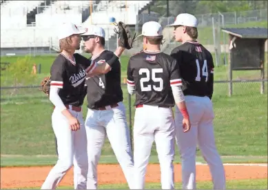  ?? Scott Herpst ?? Members of the LFO infield exchange one final glove slap before starting an inning during Thursday’s game at LaFayette. The Warriors beat the Ramblers, 10-3, to clinch a spot in the state tournament for the first time since 2012.