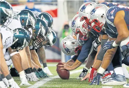  ??  ?? The Patriots, right, get set for the snap against the Eagles during a game in 2015.