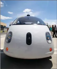  ??  ?? ROBO-CHAUFFEUR: The front of Google’s new self-driving prototype car is shown during a May 13 demonstrat­ion at Google campus in Mountain View, Calif. Hustling to bring cars that drive themselves to a road near you, Google finds itself somewhere that...