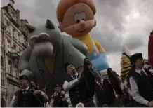  ?? — AP ?? Giant inflated balloons with shapes of comic strip characters fly during a Comic Strip Festival parade in Brussels, Belgium, on Saturday.