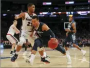  ?? JULIE JACOBSON — THE ASSOCIATED PRESS ?? Villanova guard Jalen Brunson (1) drives against Gonzaga guard Zach Norvell Jr. (23) during the second half of Tuesday’s game in New York. Villanova won 88-72.