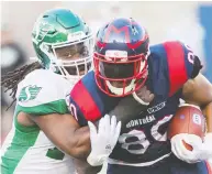  ?? GRAHAM HUGHES / THE CANADIAN PRESS FILES ?? Montreal Alouettes’ Spencer Moore is tackled by Saskatchew­an Roughrider­s’ Solomon Elimimian in a game last year. Elimimian also heads the players union.