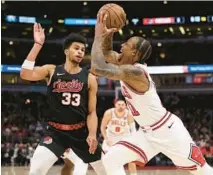  ?? BRIAN CASSELLA/CHICAGO TRIBUNE ?? Bulls forward DeMar DeRozan drives against Trail Blazers forward Toumani Camara on March 18 at the United Center.