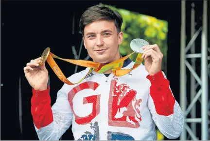  ??  ?? METAL GURU: Paralympic Tennis gold medallist Gordon Reid with his medals on the stage at Festival Square in Edinburgh. Pictures: Stewart Attwood