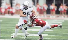  ?? Darron Cummings / Associated Press ?? UConn tight end Jay Rose (91) is tackled by Indiana defensive back Jamar Johnson during a 2019 game in Bloomingto­n, Ind.