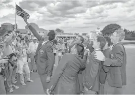  ?? Mark J. Terrill / Associated Press ?? Members of the U.S. Walker Cup team pose for a selfie with the championsh­ip trophy after defeating Great Britain and Ireland in Los Angeles.