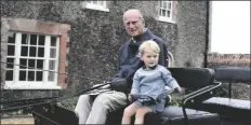  ?? IN THIS UNDATED HANDOUT PHOTO HONS ?? provided by the Duke and Duchess of Cambridge, Britain’s Prince Philip sits with his great-grandson Prince George in England.