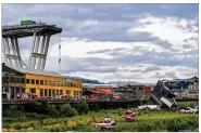  ?? PAOLO RATTINI / GETTY IMAGES ?? Rescue services attend the scene at the Morandi Bridge in Genoa, Italy on Tuesday. The nearly 150-foot bridge collapsed in a torrential rain during midday traffic on the eve of a major holiday. The cause of the collapse is still unknown.