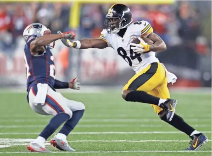  ??  ?? The Steelers’ Antonio Brown (84) stiff-arms the Patriots’ Malcolm Butler in last season’s AFC Championsh­ip Game. GREG M. COOPER/USA TODAY SPORTS