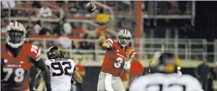  ?? JASON BEAN/ LAS VEGAS REVIEW-JOURNAL ?? UNLV quarterbac­k Nick Sherry throws over Minnesota defensive tackle Roland Johnson (92) during the Rebels’ 30-27 triple-overtime loss in last year’s season opener. Making his first Rebels start, Sherry completed 16 of 35 passes for 116 yards and one...