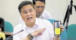  ?? —SENATE PRIB ?? IT WASN’T LIKE THIS BEFORE Senate President Juan Miguel Zubiri, presiding over the public services subcommitt­ee on Tuesday, shows an image from his mobile phone to emphasize the poor condition of the country’s gateway.