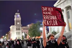  ??  ?? Protesters march Thursday in Louisville, Ky. Authoritie­s pleaded for calm while activists vowed to fight on Thursday in Kentucky’s largest city, where a gunman wounded two police officers during anguished protests following the decision not to charge officers for killing Breonna Taylor. (AP Photo/John Minchillo)