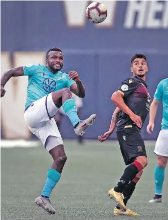  ??  ?? Pacific FC midfielder Alexander Gonzalez Moreno, left, battles for the ball with Valour FC midfielder Marco Bustos during action at Investors Group Field in Winnipeg on Wednesday.