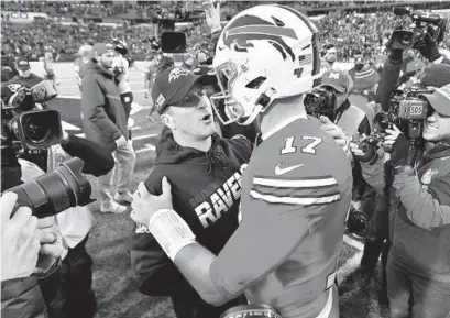  ?? ADRIAN KRAUS/AP ?? Ravens coach John Harbaugh, left, talks with Bills quarterbac­k Josh Allen after a game last season in Orchard Park, N.Y.