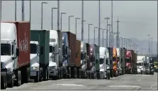  ?? BEN MARGOT — THE ASSOCIATED PRESS ?? Trucks hauling shipping containers wait to unload at the Port of Oakland in Oakland in this 2019photo. The Commerce Department estimate on Thursday of how the U.S. economy performed in the first quarter of 2020was bleak.