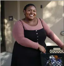  ?? NHAT V. MEYER — STAFF ARCHIVES ?? De Anza College student Oyantai Rodriguez, shows the food she received from West Valley Community Services. The WVCS Park-it Market, which serves as a “shoppable” food pantry at no cost to clients, makes regular stops at De Anza.