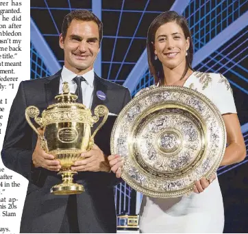  ?? AFP ?? Wimbledon men’s and women’s singles champions, Switzerlan­d’s Roger Federer (left) and Spain’s Garbine Muguruza posing with their trophies at the Champions Dinner in central London.