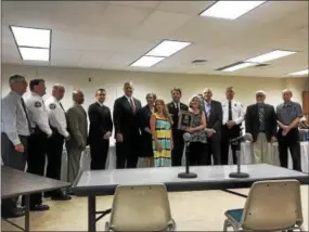  ?? GINGER RAE DUNBAR — DIGITAL FIRST MEDIA ?? District Attorney Tom Hogan presents the West Chester Police Department with a commendati­on for the arrest and conviction of Barry Baker Jr. who assaulted a man with cerebral palsy. Pictured are the police, West Chester Borough Council members and...