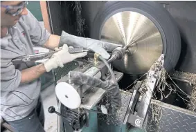  ??  ?? Pat Butler works the lathe at the factory.