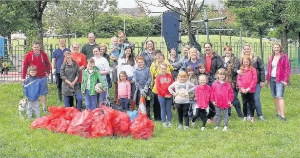  ??  ?? Around 40 residents of the Broadlands estate in Bridgend carried out a litter pick to tackle the waste accumulati­ng in areas not maintained by the council