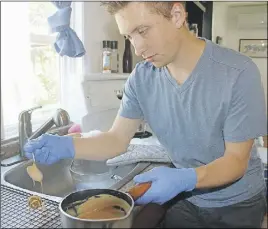  ?? lyNN CurwiN/Truro Daily News ?? Tyler Jollimore pours a peanut butter glaze over Pomace handmade dog treats.