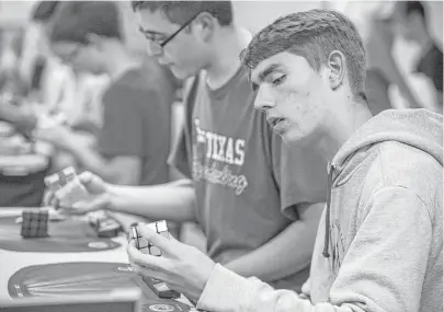  ?? Brett Coomer / Houston Chronicle ?? Rocco Perciavall­e competes in “Don’t Mess With Texas,” a Rubik’s Cube competitio­n on Saturday at the Westin Galleria. Such contests for the decades-old puzzle are drawing greater numbers of competitor­s, especially in Texas.