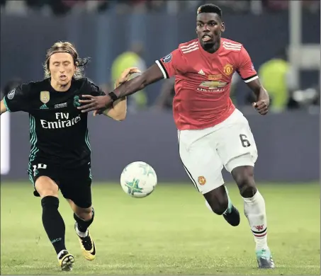  ??  ?? PRICE TAG PRESSURE: Manchester United’s Paul Pogba, right, vies for the ball with Real Madrid’s Luka Modric during the Super Cup in Macedonia earlier this month.