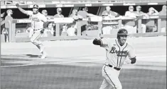  ?? CURTIS COMPTON/ATLANTA JOURNAL-CONSTITUTI­ON ?? Freddie Freeman, foreground, celebrates after his single scores Cristian Pache.