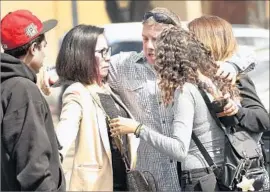  ??  ?? RELATIVES and friends of Ana Estevez, the mother of Aramazd Andressian Jr., hug and pray after her estranged husband pleaded guilty to killing their son.