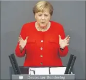  ?? Michele Tantussi Getty Images ?? “THERE is no excuse or justificat­ion for ... the use of violence and Nazi propaganda,” Angela Merkel said.