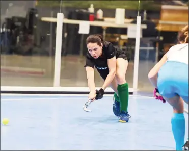  ??  ?? Trisha Woodroffe (left) of Guyana attempts a pass against Uruguay in the 2021 Indoor Pan Am Cup (IPAC) yesterday