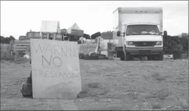  ?? Jesse Moya/The Taos News via AP ?? Warning: This Aug. 5, 2018 photo shows a "no trespassin­g" sign outside the location where people camped near Amalia, N.M. Three women believed to be the mothers of 11 children found hungry and living in a filthy makeshift compound in rural northern New Mexico have been arrested, following the weekend arrests of two men, authoritie­s said Monday.