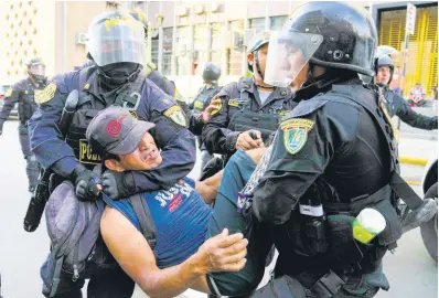  ?? AP ?? Police detain a protester marching against President Dina Boluarte in Lima, Peru on Thursday.