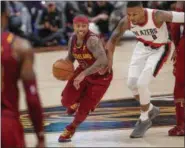  ?? TIM PHILLIS — THE NEWS-HERALD ?? Isaiah Thomas drives with the Blazers’ Damian Lillard in pursuit Jan. 2. Thomas had 17 points in his Cavs’ debut, a 127-110 victory.