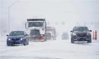  ?? Photograph: Sue Ogrocki/AP ?? Cars and plows are driven during a winter storm on Sunday in Oklahoma City.