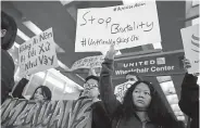  ?? Chris Sweda, Chicago Tribune via The Associated Press ?? Protesters at Chicago’s O’Hare Internatio­nal Airport hold signs condemning the removal of David Dao from a United Airlines flight in April 2017.